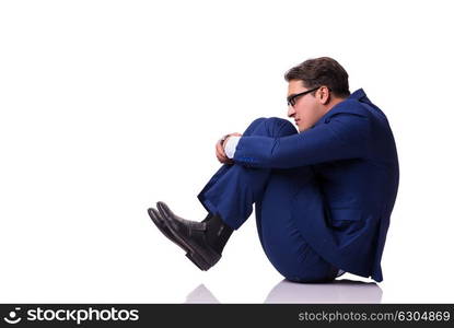 Businessman sitting on the floor isolated on white