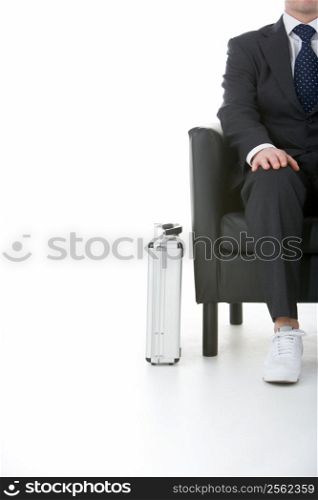 Businessman Sitting Wearing Sneakers