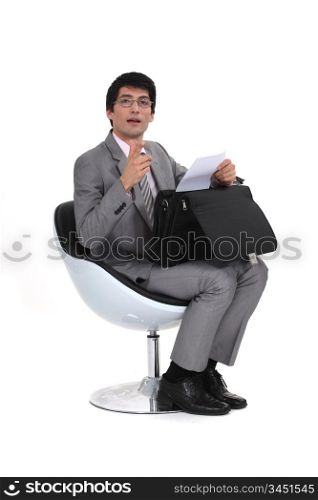 Businessman sitting with a briefcase