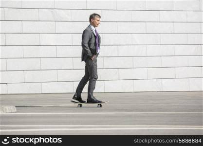Businessman skateboarding on street