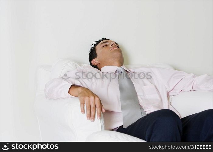 Businessman sleeping in an armchair