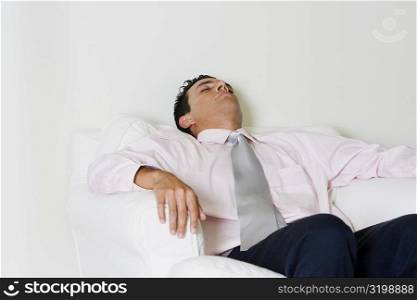 Businessman sleeping in an armchair