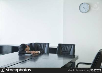 Businessman sleeping in office room