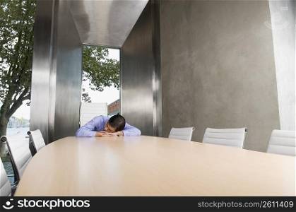 Businessman sleeping on a conference table