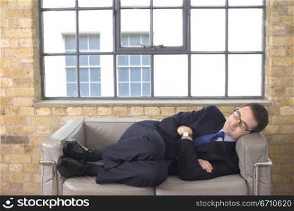 Businessman sleeping on a couch