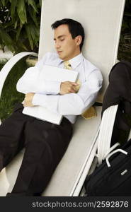 Businessman sleeping on a lounge chair