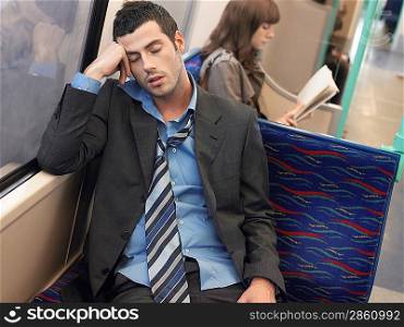 Businessman Sleeping on Commuter Train