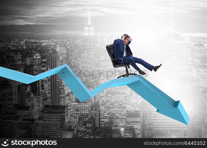 Businessman sliding down on chair in economic crisis concept