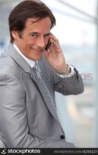 Businessman smiling whilst phoning
