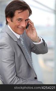 Businessman smiling whilst phoning