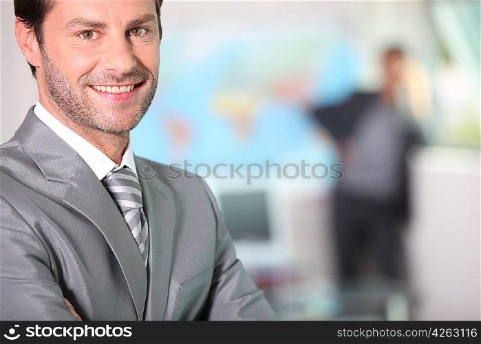 Businessman smiling with arms folded