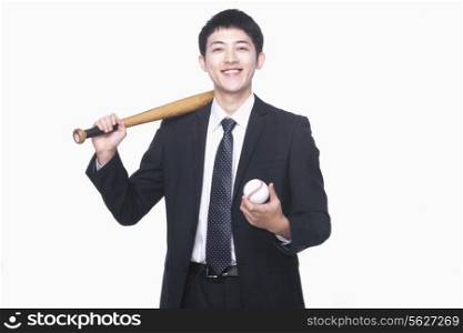 Businessman smiling with bat and baseball