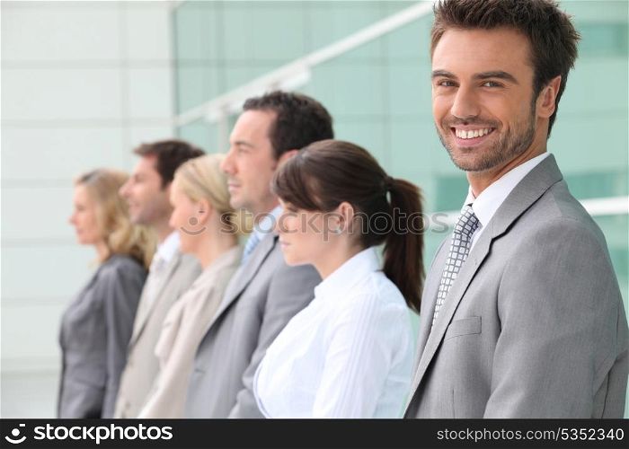 businessman smiling with team