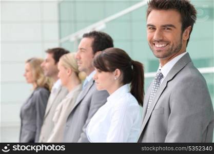 businessman smiling with team