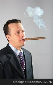 businessman smokes a cigar