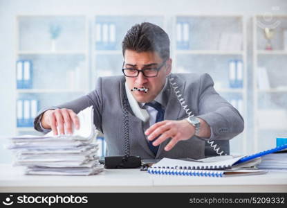 Businessman smoking in office at work