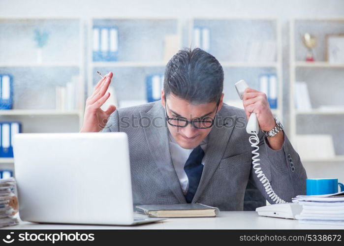 Businessman smoking in office at work