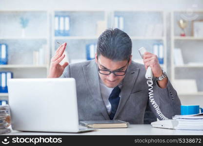 Businessman smoking in office at work