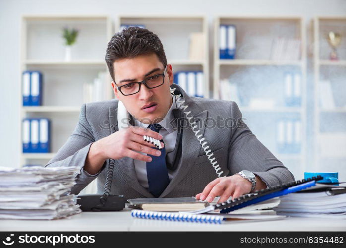 Businessman smoking in office at work