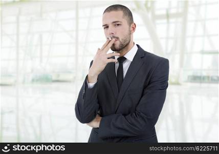 businessman smoking isolated at the office