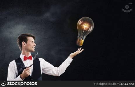 Businessman smoking pipe. Handsome young businessman thinking over ideas and smoking pipe
