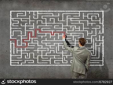 Businessman solving labyrinth problem