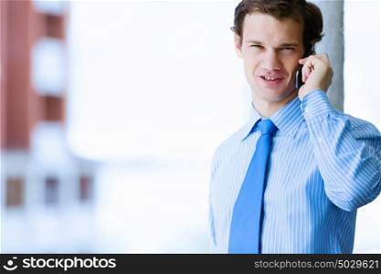 Businessman speaking mobile phone. Image of handsome businessman speaking on mobile phone