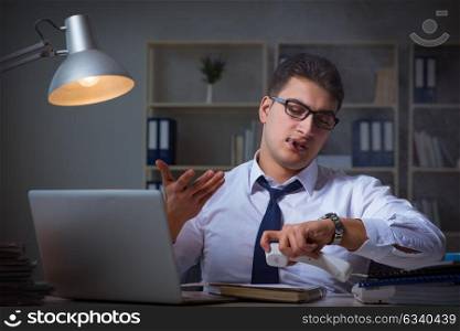 Businessman speaking on phone and smoking in office