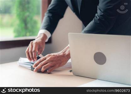 Businessman stacking document after checking financial and accounting report of business project.