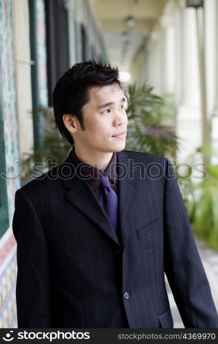 Businessman standing and looking away