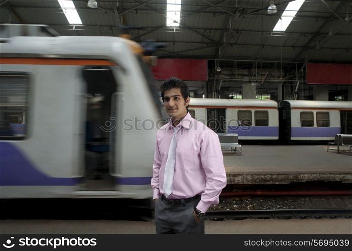 Businessman standing at a train station