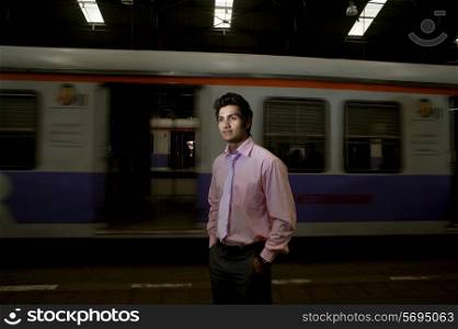 Businessman standing at a train station