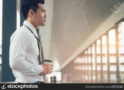 Businessman standing at building walkway company with hope concept.