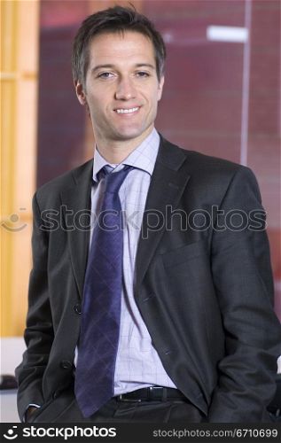 Businessman standing in an office and smiling