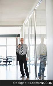 Businessman standing in Corridor portrait.