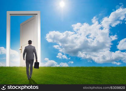 Businessman standing in front of door into future