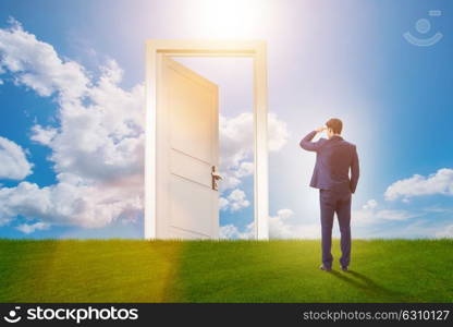 Businessman standing in front of door into future