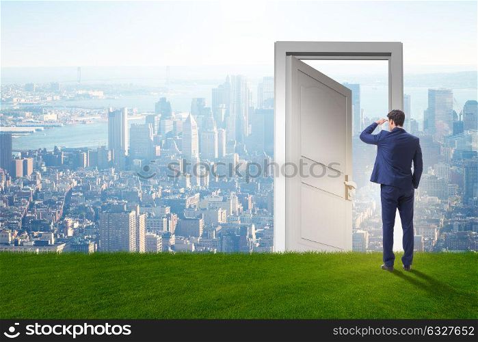 Businessman standing in front of door into future