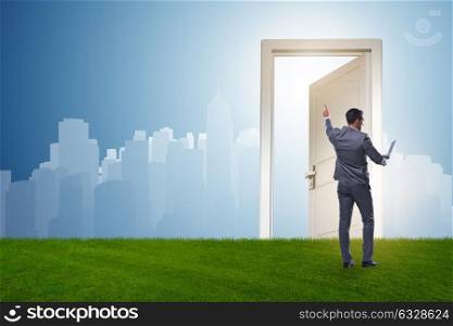Businessman standing in front of door into future. The businessman standing in front of door into future