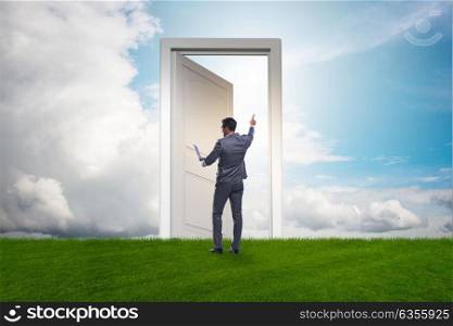 Businessman standing in front of door into future. The businessman standing in front of door into future