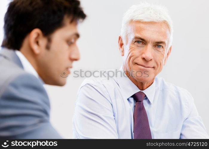 Businessman standing in office smiling at camera. Success and professionalism in person