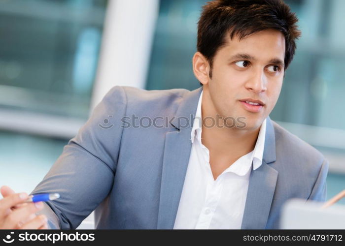 Businessman standing in office smiling at camera. Success and professionalism in person