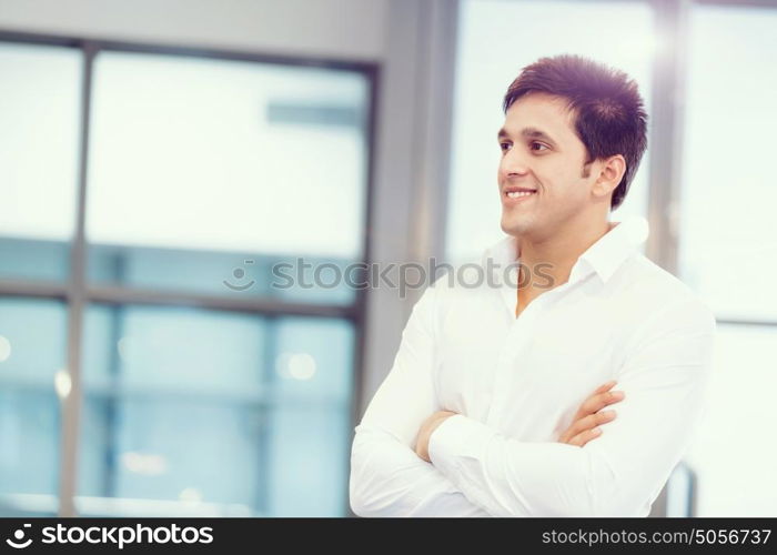 Businessman standing in office smiling at camera. Success and professionalism in person