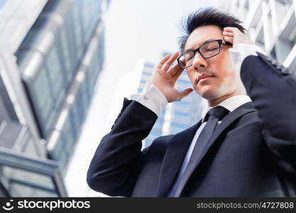 Businessman standing in street and trying to concentrate. I need to concentrate