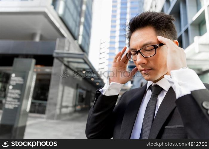Businessman standing in street and trying to concentrate. I need to concentrate