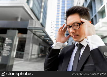 Businessman standing in street and trying to concentrate. I need to concentrate