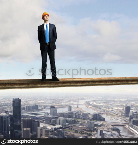 Businessman standing in suit on the construction site