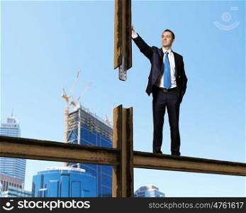 Businessman standing in suit on the construction site