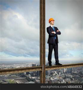 Businessman standing in suit on the construction site