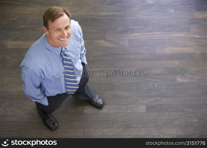Businessman standing indoors smiling
